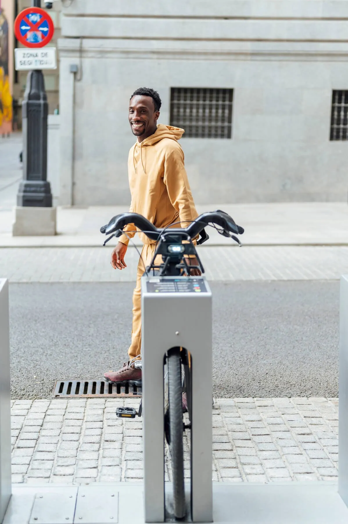 Man walking with a hire bike in the city